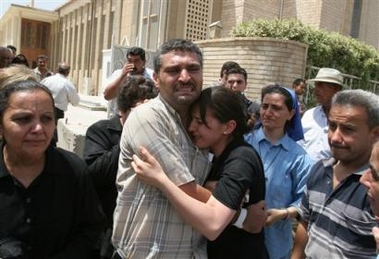 The brother and sister of Mr. Ayad Dawood Gergis (Gewargis) mourn after their brother's funeral services at a local church, Sunday, 14 August in the Dora district of Baghdad. (AP Photo/Karim Kadim) 